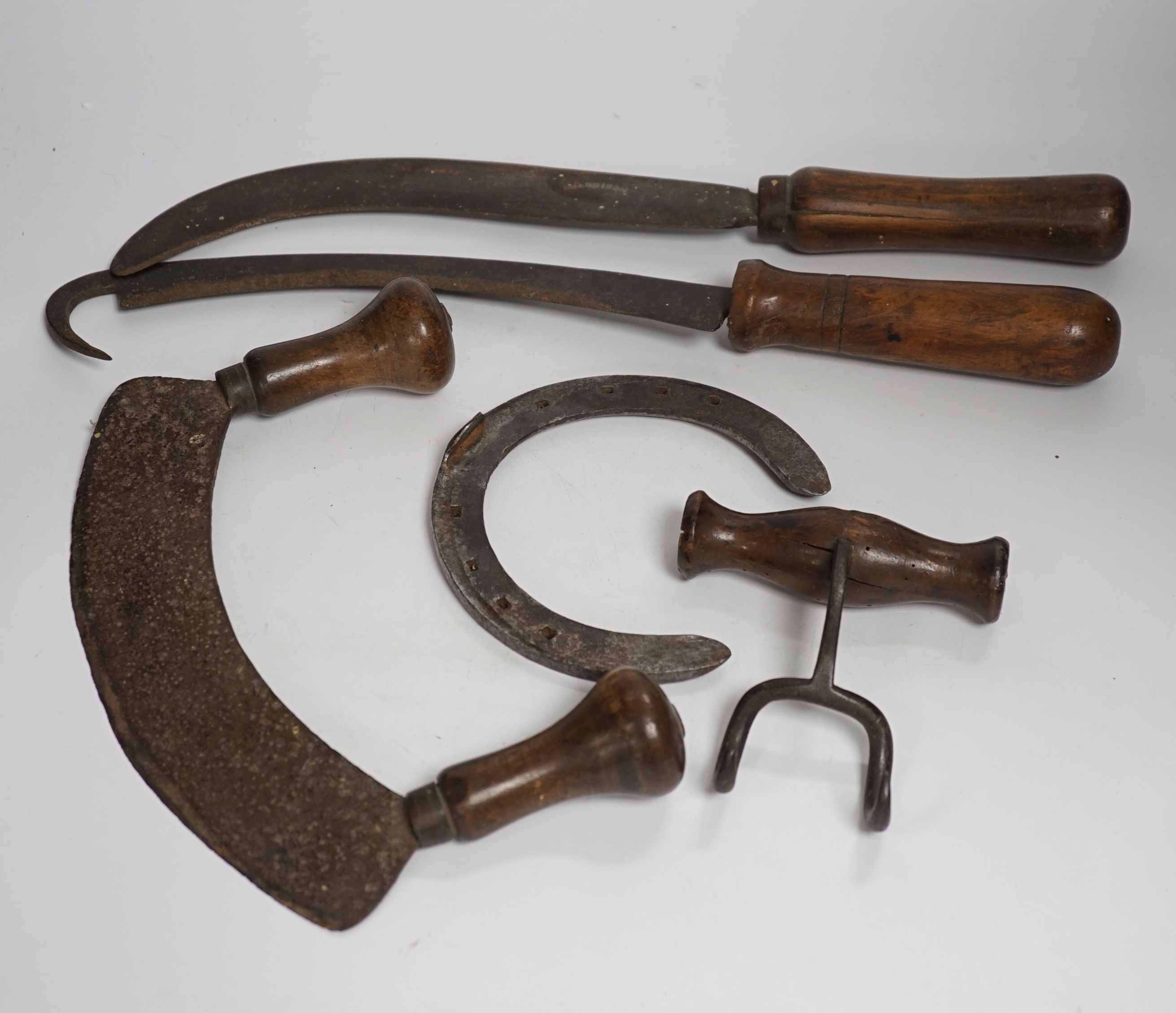 An assorted collection of used 20th century horticultural, shoe making and cooking tools